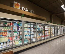 Dairy aisle with items enclosed in coolers