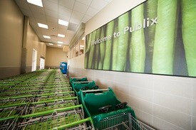 Publix shopping carts lined up in lobby with traditional decor Welcome to Publix sign in top right 