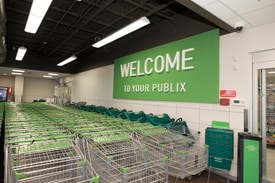Publix shopping carts lined up in lobby with new decor Welcome to Publix sign in top right
