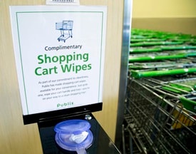Shopping cart wipes stand with sign