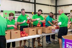 Publix president and associates sort produce donated by the company at Dare to Care Food Bank following the groundbreaking.